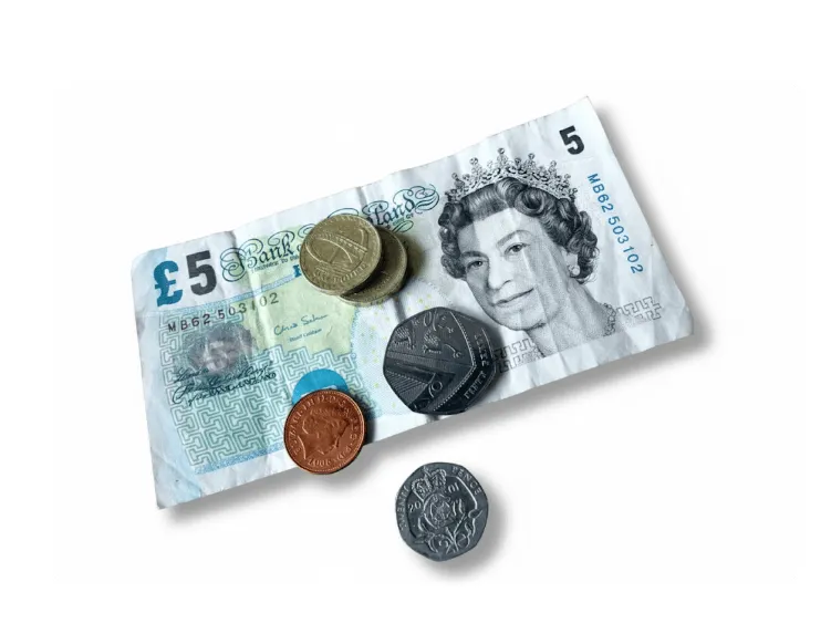 A hand holding some banknotes